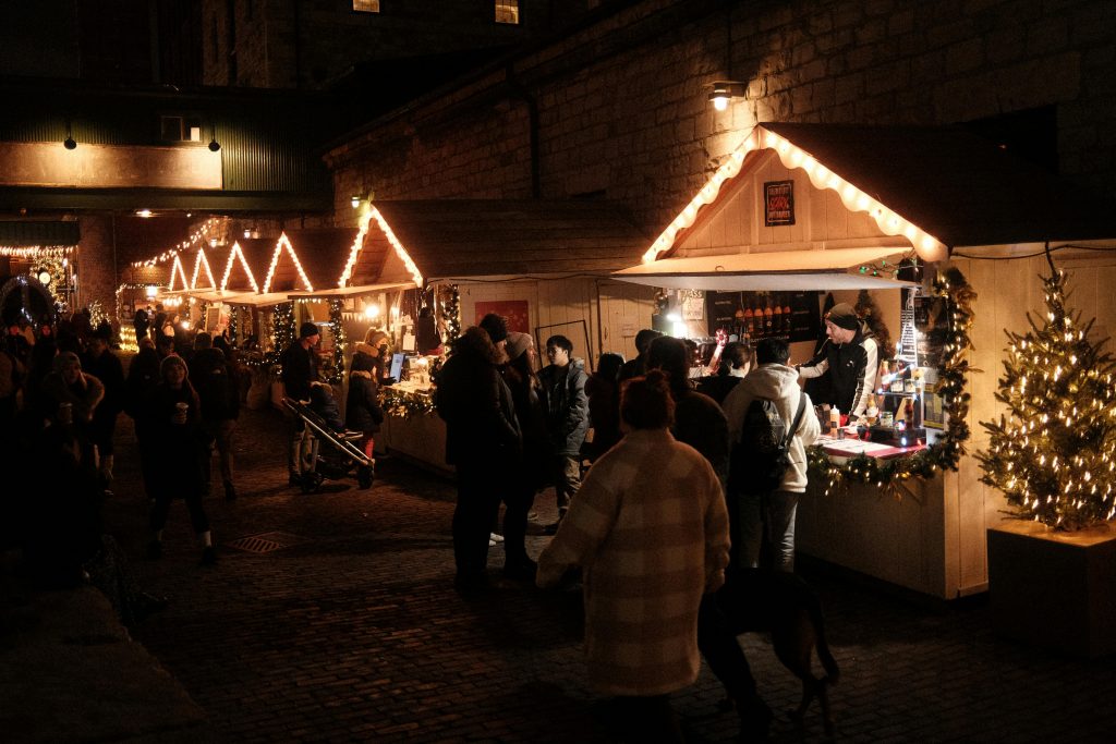 People enjoying winter cocktails at Christmas markets.